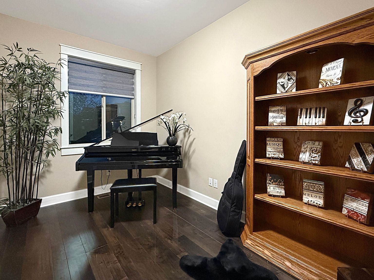 Dedicated office with the same engineered hardwood, generous casement window, and built-in millwork. The McKenna plan's main-floor study, suitable for a piano or a writing desk.